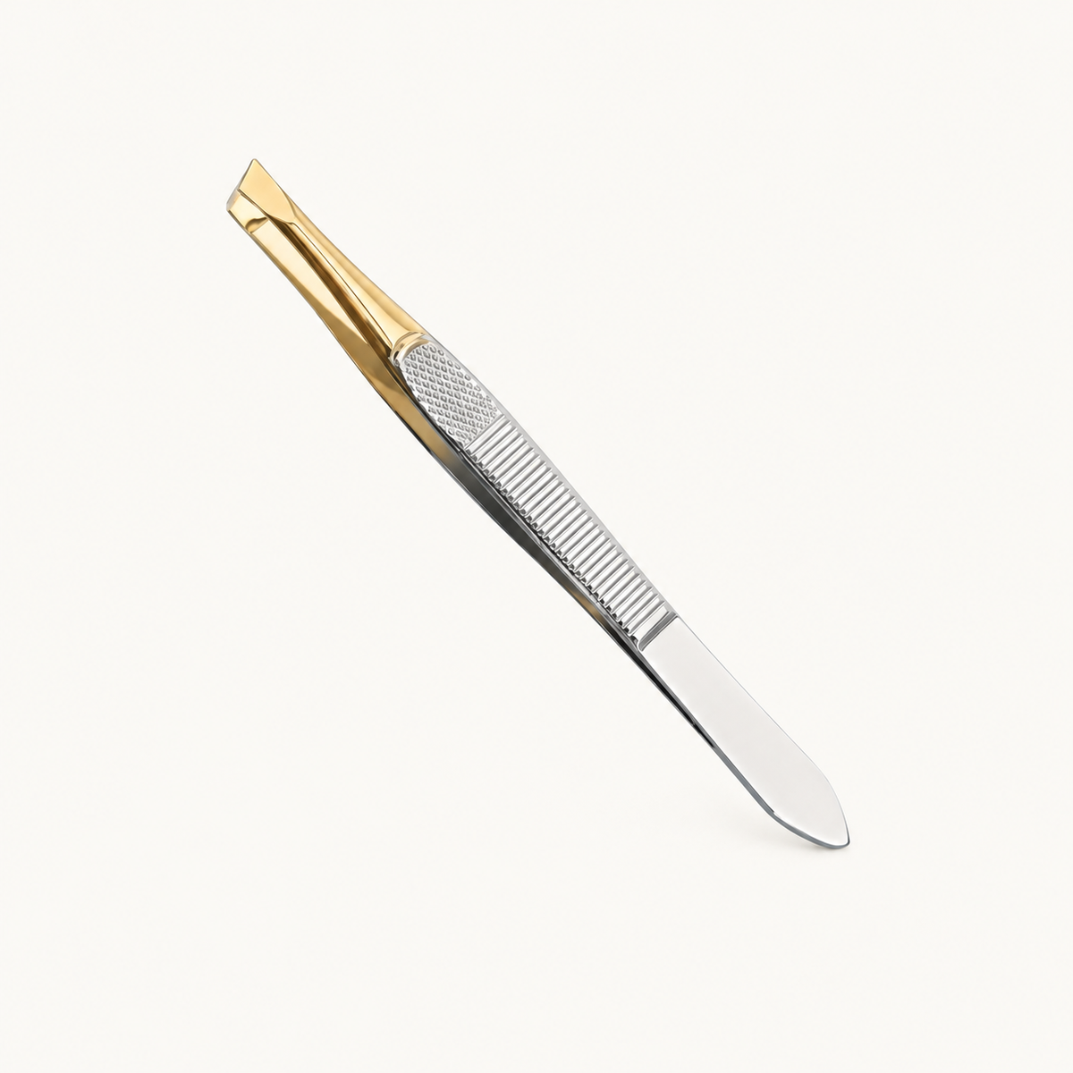 One Body Bliss brow shaping tweezer with gold jaws and a silver handle on warm ivory