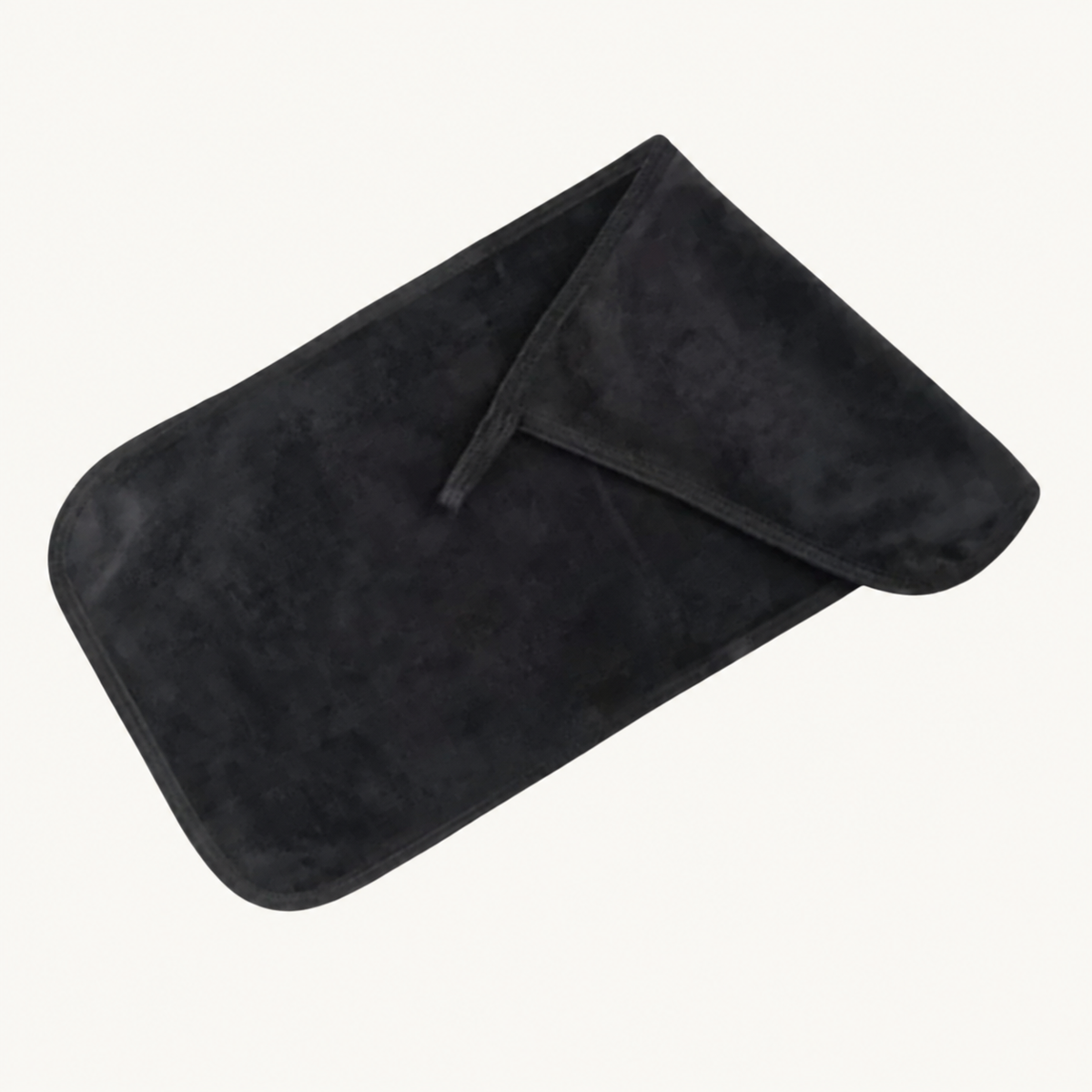 One folded black Body Bliss cleansing makeup remover cloth on a warm ivory background