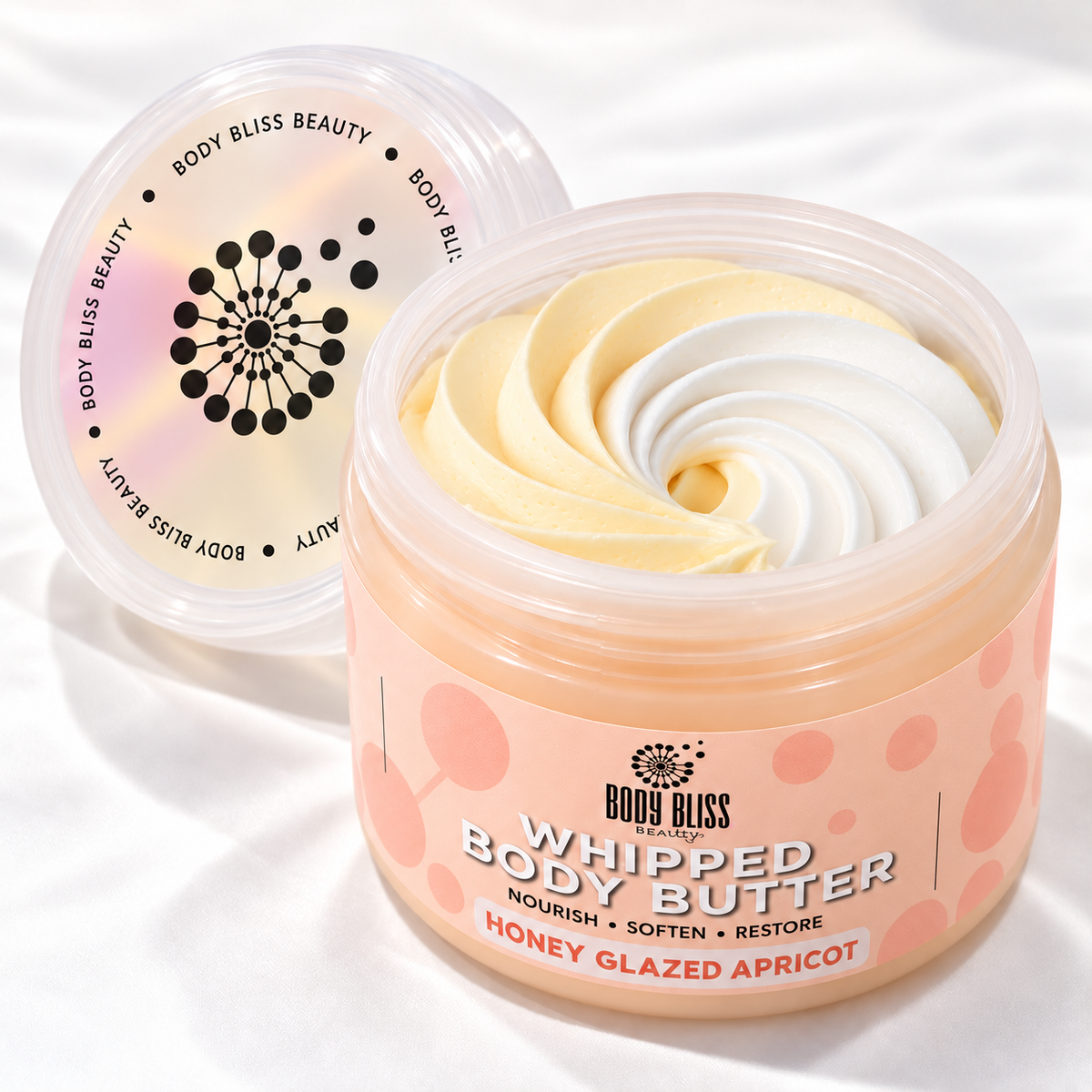 Body Bliss Honey Glazed Apricot whipped body butter in a clear jar with a peach label and pale-yellow and white swirls, on a soft wave backdrop.