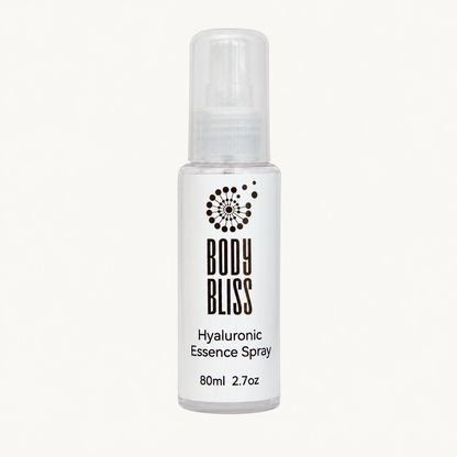 Body Bliss Hyaluronic Essence Spray 80ml bottle on a warm ivory background