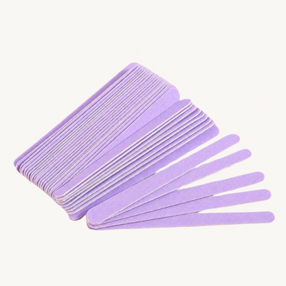 Stacked and fanned lavender Body Bliss nail files on a warm ivory background