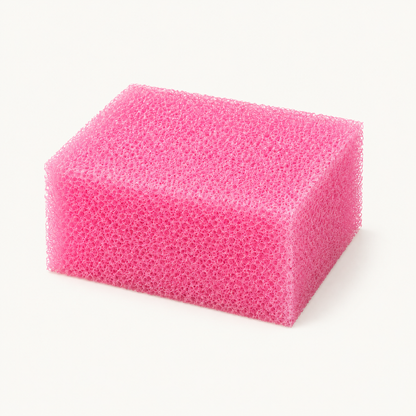 Pink Body Bliss exfoliating body sponge on a warm ivory background