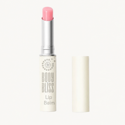 Pink Body Bliss lip balm with its ivory cap alongside on a warm ivory background