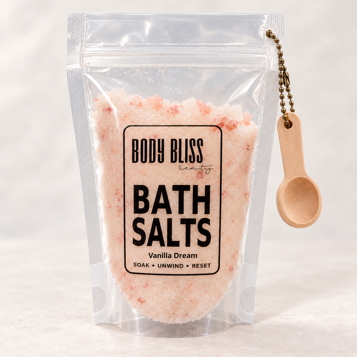 Body Bliss Vanilla Dream Bath Salts in a clear pouch with wooden scoop
