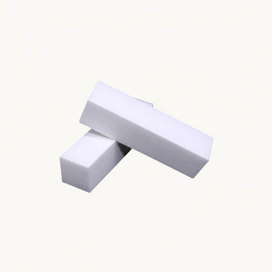 Two white Body Bliss buffing blocks on a warm ivory background