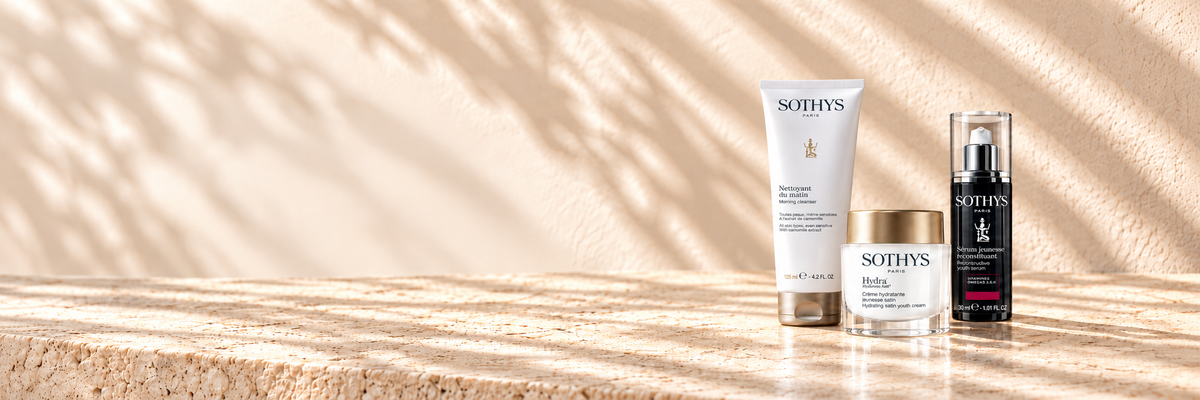 Sothys skincare products in a sunlit ivory stone setting.